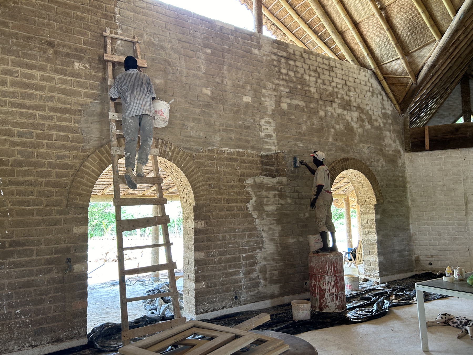 Local craftspeople plastering the walls